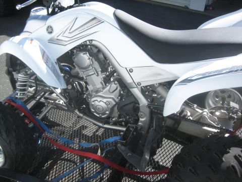 1995 Ford Bronco - A white Yamaha ATV is secured to a trailer with red and blue straps, its engine and suspension clearly visible.
