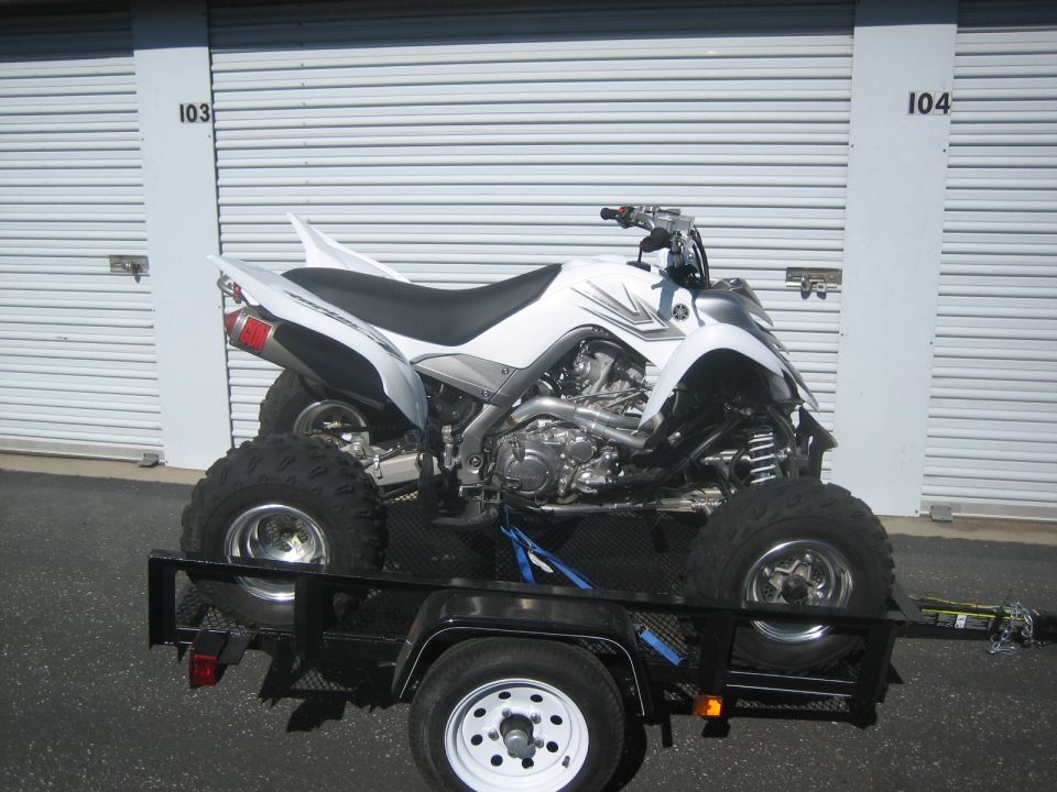 White ATV on a trailer, side view