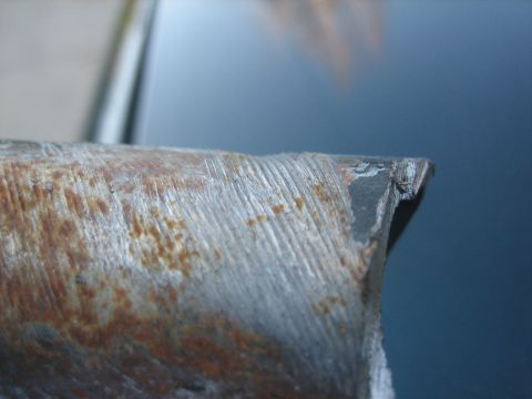 1995 Ford Bronco - A close-up view of a corroded metal component, showing signs of wear and damage.