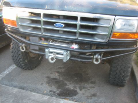 1995 Ford Bronco - Front view of a 1995 Ford Bronco showing the grille, bumper, and winch assembly.