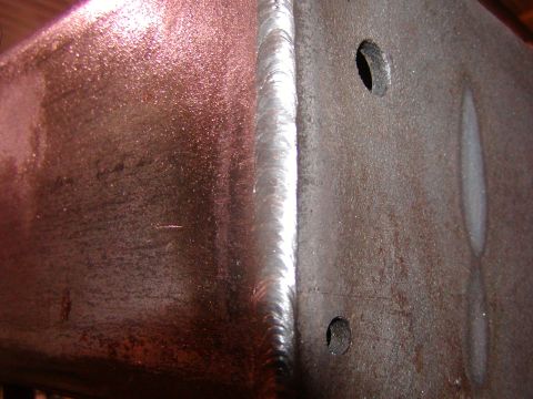 1991 Ford Bronco - Metal frame section with a clean weld and visible bolt holes.