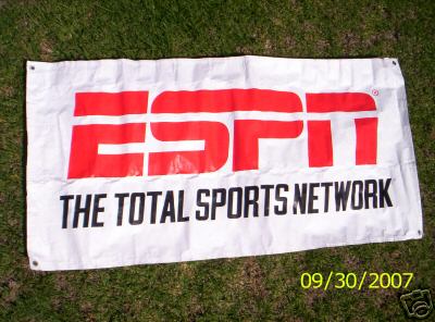 1993 Ford C-350 (Centurion Conversions) - A white banner displaying the ESPN logo and 'THE TOTAL SPORTS NETWORK' text is laid out on a grassy surface.