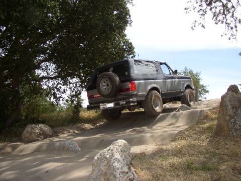 1989 Ford Bronco - Ford Bronco navigating a rocky off-road course.
