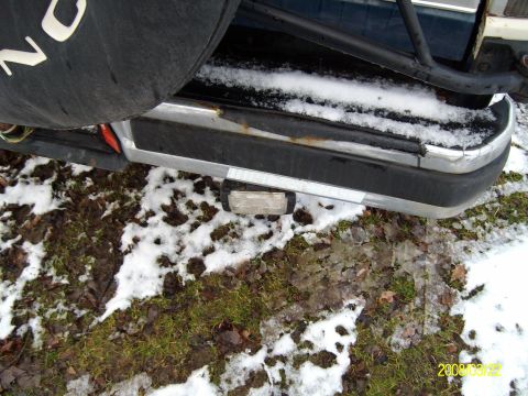 1988 Ford Bronco - Rear view of a 1988 Ford Bronco, showing the bumper and spare tire cover in a snowy environment.