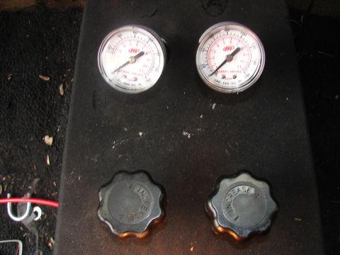 1973 Ford Ranchero - Close-up of two pressure gauges and control knobs, possibly from a vehicle's interior or a piece of equipment.
