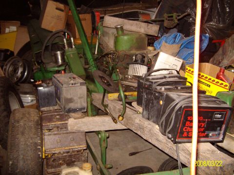 1988 Ford Bronco - It's hard to tell with all the junk, but there IS a John Deere modle MC crawler under all that stuff. Partialy torn apart for clutch work.