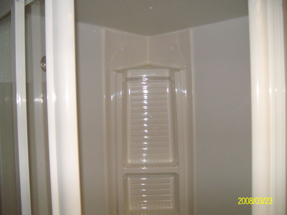 interior shower stall with white walls and curtains