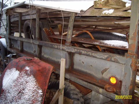 1988 Ford Bronco - This old truck bed is covered in snow and appears to be in disrepair.