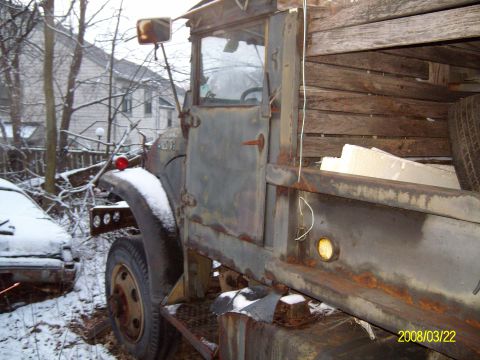 1988 Ford Bronco - A weathered truck sits in the snow next to another vehicle.