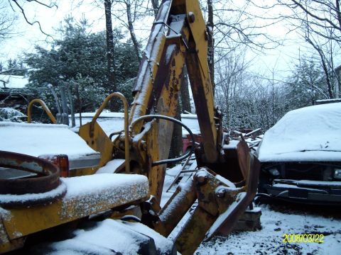 1988 Ford Bronco - This backhoe is the offical moving vehecile. By that I mean if it doesn't move under its own power it, therefore, gets manhandled by this...