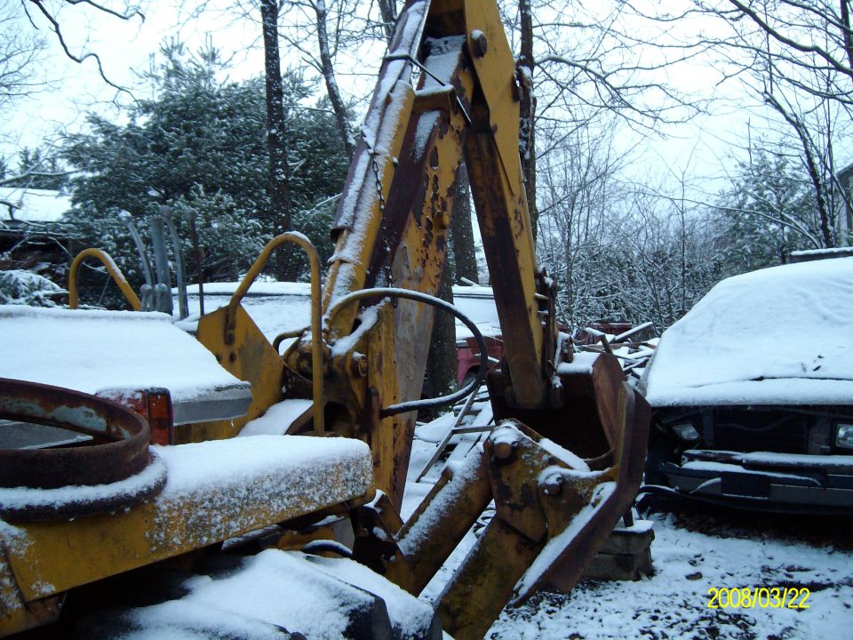 This backhoe is the offical moving vehecile. By that I mean if it doesn't move under its own power it, therefore, gets manhandled by this...