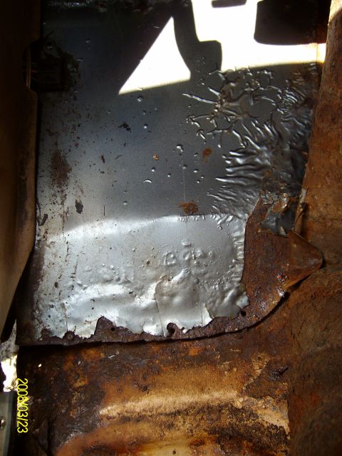 1988 Ford F-150 - Significant rust and deterioration are visible on this vehicle's undercarriage component.