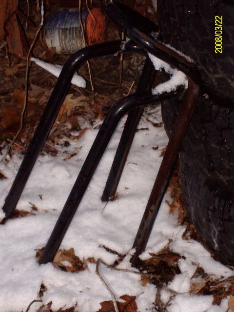 1988 Ford Bronco - Unidentified metal frame parts are seen in the snow, possibly related to vehicle upgrades or repairs.