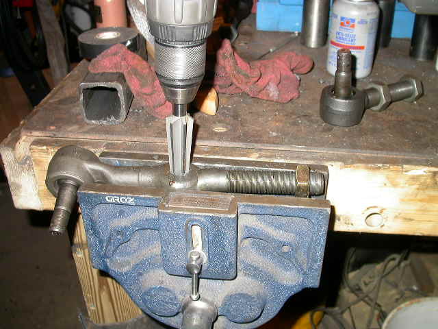 Reaming passenger side TRE for the drag link end.