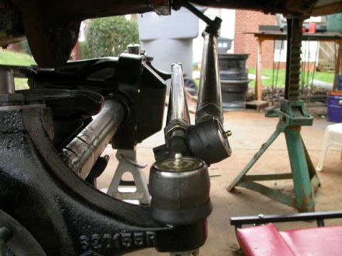 1990 Ford Bronco - Vehicle suspension components, including tie rod ends and steering linkage, are shown on jack stands.