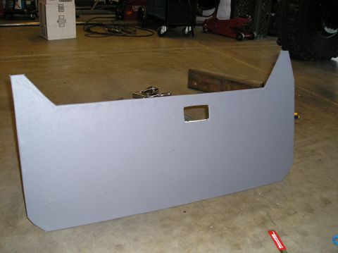 1986 Toyota Hilux - A gray door panel with a square cutout is shown on a workshop floor.