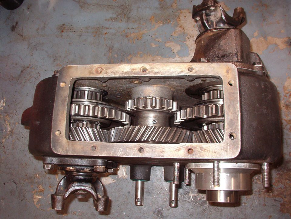 Neutral
Both sliding gears (and the shift rails) are centered, UNlocking both outputs. The pills prevent the front output shift rail from moving; only the rear can move either direction.

The Aluminum sleeve & stub shaft at the lower R are for the Advance Adapters kit for the AOD.  Removing that shaft from the t-case allows about a dozen roller bearings to fall loose into & out of the t-case.  Finding & re-installing them is a challenge.
