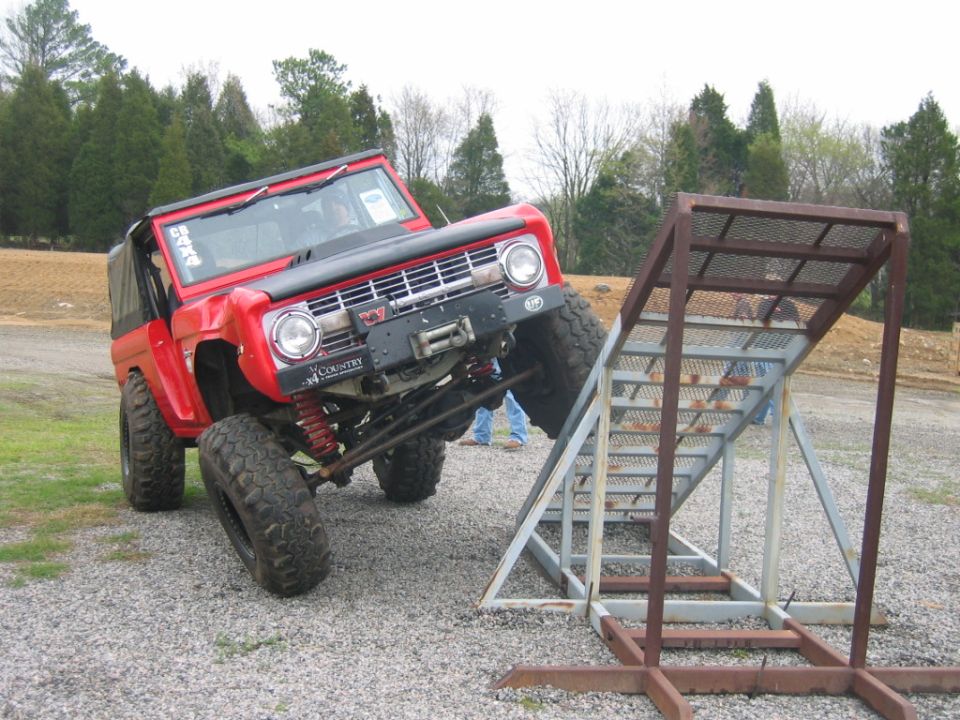 Red off-road Bronco on a metal ramp