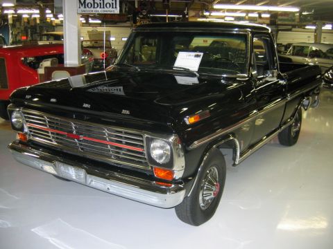 1992 Ford Mustang - This black 1969 Ford F-Series pickup truck is displayed indoors, showing its front end and grille.
