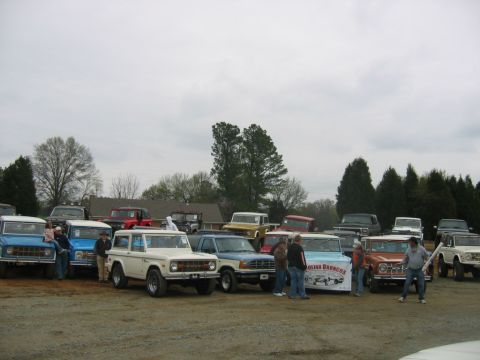 1992 Ford Mustang - A gathering of classic Ford Broncos and other trucks on a cloudy day.