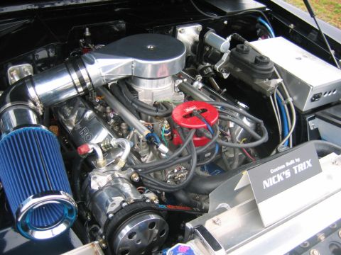 1992 Ford Mustang - A detailed view of a custom engine bay, chrome components, a blue air filter, and a sign indicating it was custom built by Nick's Trix.