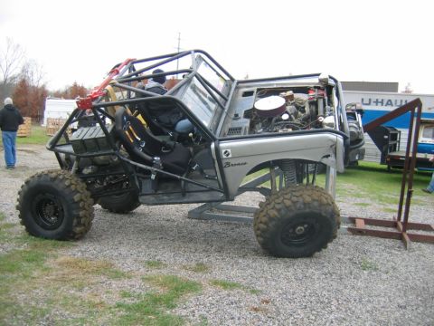 1992 Ford Mustang - A heavily modified off-road vehicle with a custom roll cage and exposed engine is shown from the side.