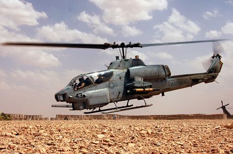 1986 Ford Bronco - A US Marine Corps AH-1 Cobra attack helicopter is shown in flight over a desert landscape with another helicopter in the background.