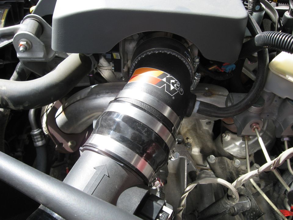 K&N intake tube connected to engine components, showing hose clamps and wiring