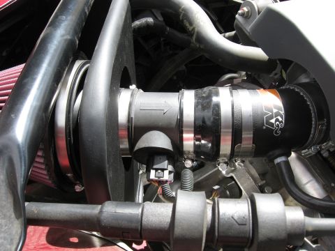 2004 Pontiac Grand Prix - The K&N air intake system is visible, a red filter and black tubing with metal clamps.