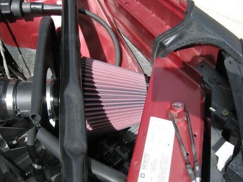 2004 Pontiac Grand Prix - Close-up of an engine bay showing an aftermarket air filter and associated components.