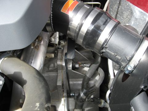 2004 Pontiac Grand Prix - Close-up of an engine's intake system, a K&N air filter and metal clamps.