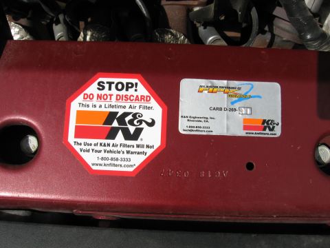 2004 Pontiac Grand Prix - Engine part with K&N stickers, including warranty information and part number.