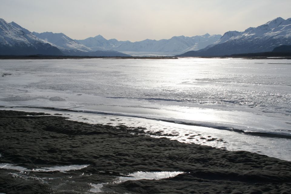 frozen lake with mountains in background