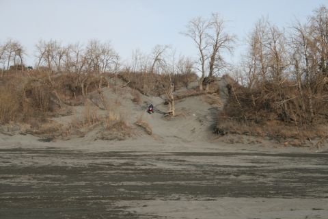 2003 Jeep TJ - A lone motorcycle navigates a sandy incline amidst a barren, winter landscape.