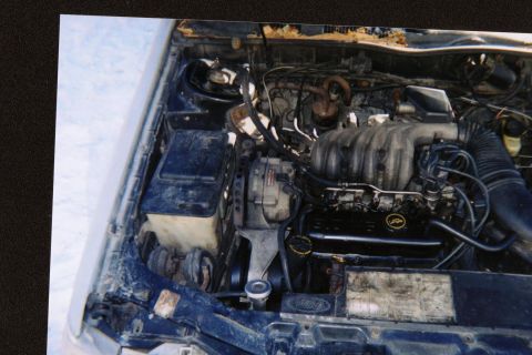 1987 Mercury Sable - The engine bay of a vehicle, showing the V6 engine and associated parts.