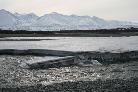 2003 Jeep TJ - A frozen river with large ice floes in the foreground, set against a backdrop of snow-covered mountains and a glacier.