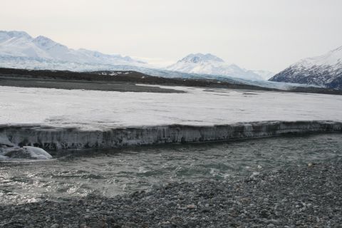 2003 Jeep TJ - Frozen river and ice formations with mountains and glacier in the distance.