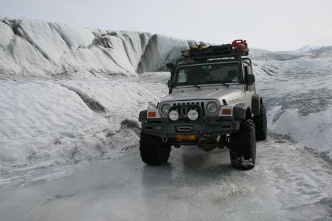 2003 Jeep TJ - A silver 2003 Jeep Wrangler navigates a glacial landscape, its off-road capabilities in a snowy environment.