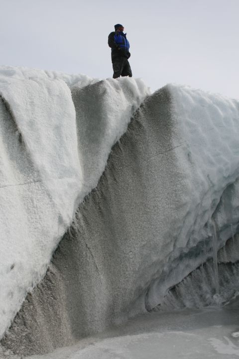 2003 Jeep TJ - A person surveys the icy landscape from a high point on a glacier.