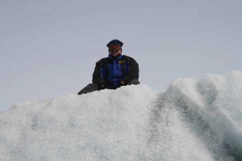 2003 Jeep TJ - A person sits atop a large ice formation, likely on a glacier, under a pale sky.