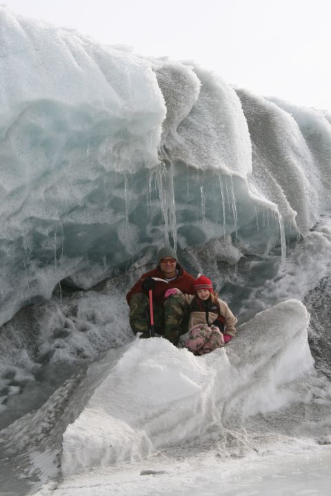 2003 Jeep TJ - Two people pose for a photo in front of a large ice formation, possibly a glacier.