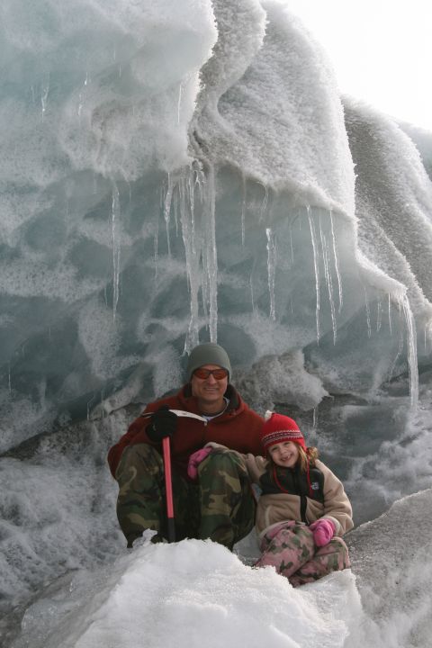 2003 Jeep TJ - Two individuals, a man and a child, are photographed in a snowy environment against a backdrop of glacial ice formations.