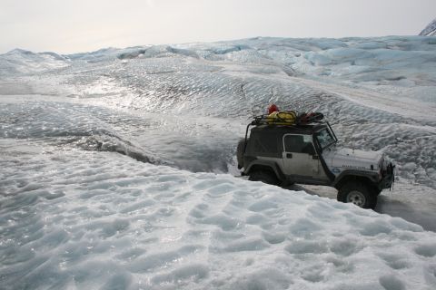 2003 Jeep TJ - A white Jeep Wrangler navigates a treacherous path across a vast, icy glacier.