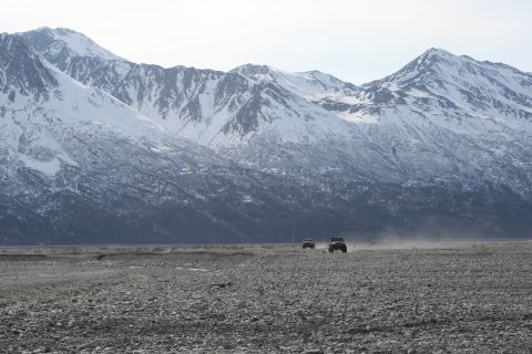 2003 Jeep TJ - Two Jeep TJs traverse a rocky landscape under a vast mountain range.