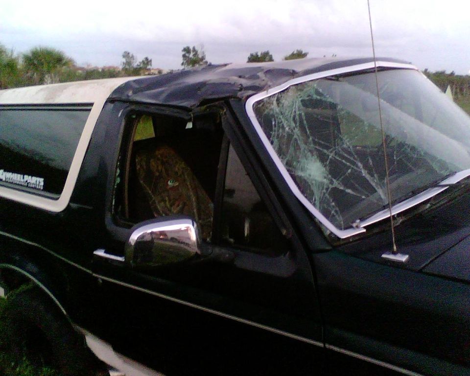 Damaged 1993 Ford Bronco with cracked windshield and dented roof