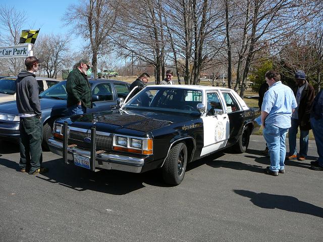 Black and white police car with a push bumper, parked outdoors