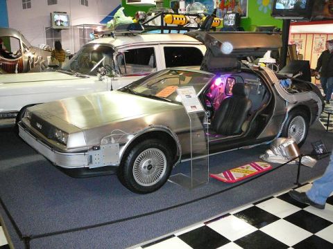 1997 Mercury Grand Marquis - DeLorean DMC-12 time machine from Back to the Future, displayed with another vehicle.