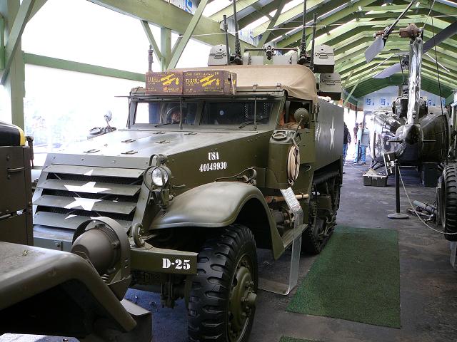 Olive drab half-track military vehicle with machine guns and USA 40149930 markings