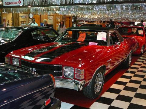 1997 Mercury Grand Marquis - A red 1970 Chevrolet El Camino SS is parked indoors with other vehicles, displaying its distinctive body style.