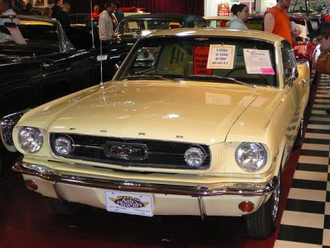 1997 Mercury Grand Marquis - Yellow 1965 Ford Mustang coupe on display at the Volo Auto Museum.